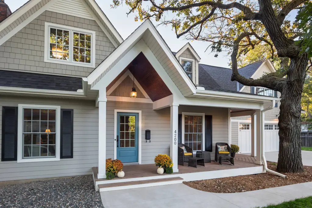 Home exterior with light gray siding and white trims by a painter in Nantucket, MA.