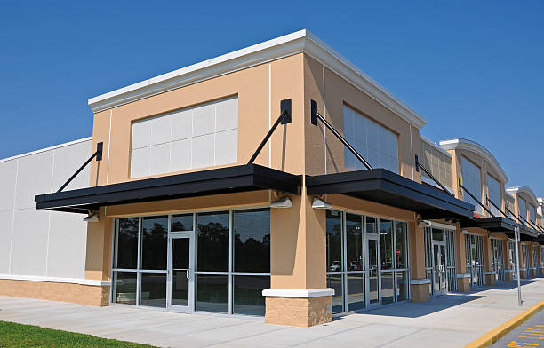 Office building with beige exterior walls and white trim by a commercial painting in Cape Cod, MA.