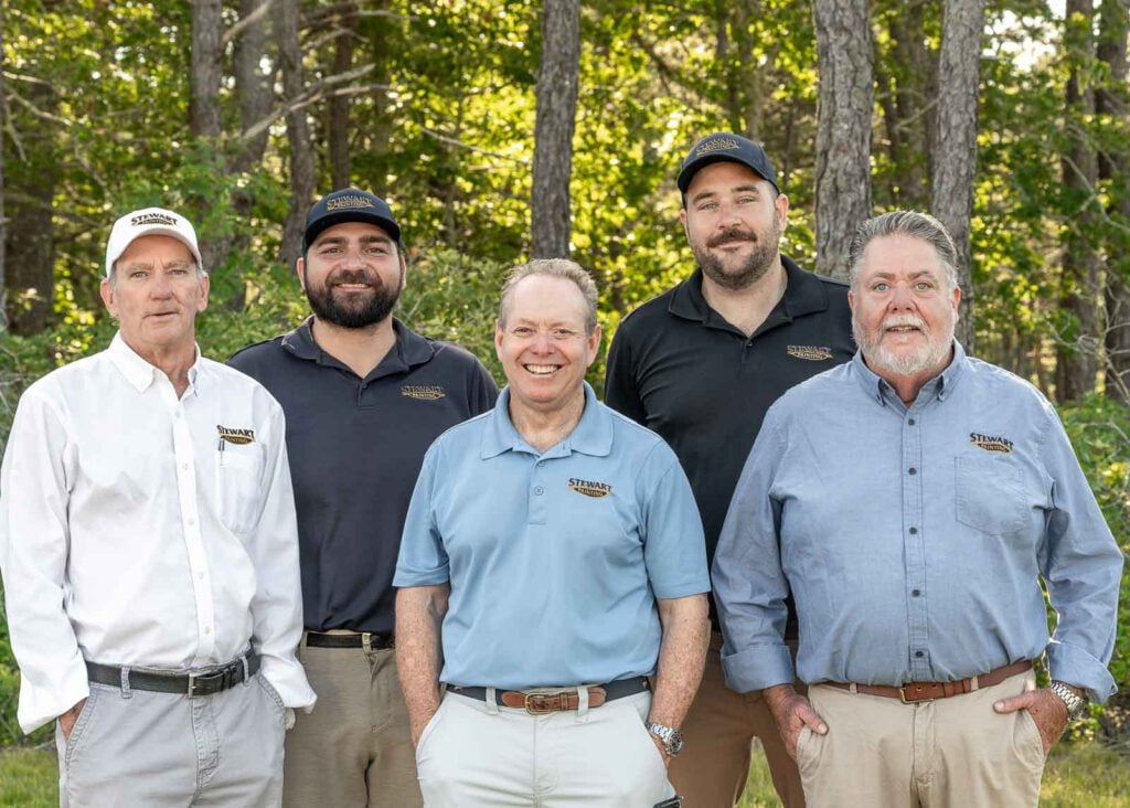 Five members of the Sales Estimator Team standing in front of trees.